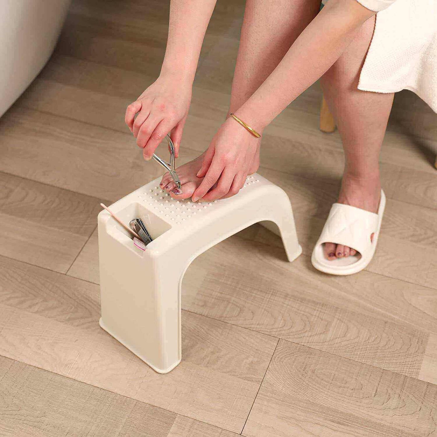 Dark Blue Shower Foot Rest Stool for Shaving, using nail clipper