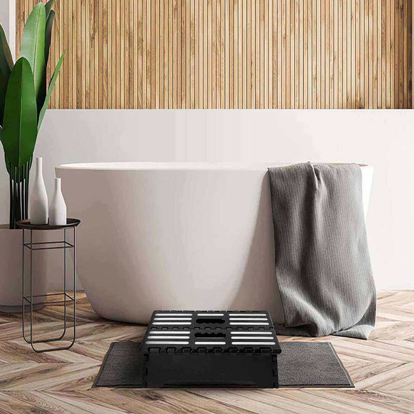 Lightweight plastic folding step stool in black, item beside a bathtub