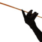 slim gold Audrey Hepburn cigarette holder for women and men, prop style in a hand with black glove