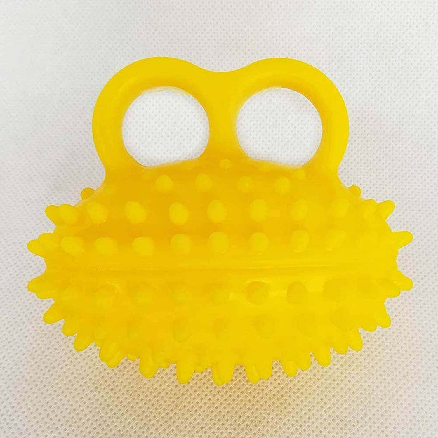 Spiky massage ball for hand and finger exercises, item on a cloth